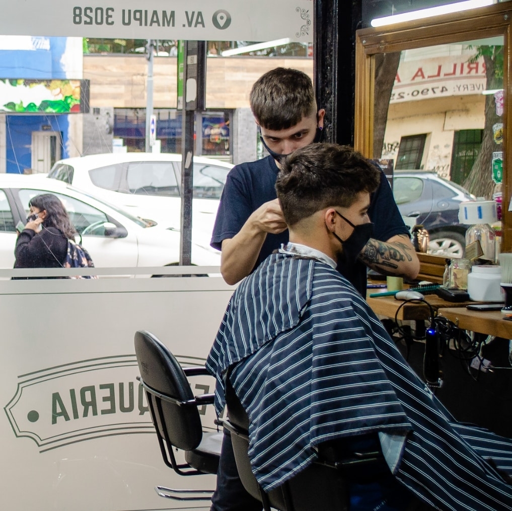 Barbero de Estilo Urbano BarberShop realizando un corte de cabello